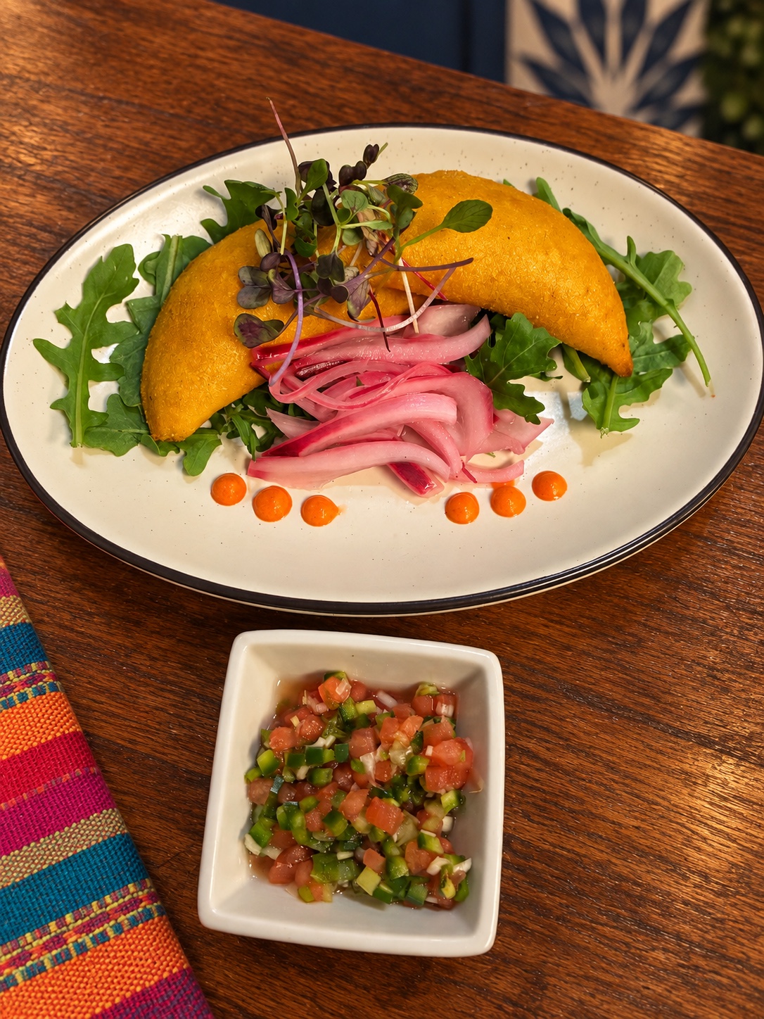 Golden empanadas with greens, pickled onion and salsa